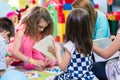 Group of kids applying colorful plasticine during educational activity