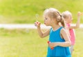 Group of kids blowing soap bubbles outdoors Royalty Free Stock Photo