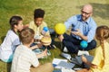 Group of Kids Enjoying Astronomy Lesson Outdoors