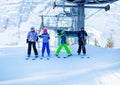 Group of kids exiting mountain ski chairlift Royalty Free Stock Photo