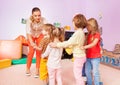 Group of kids go after each other with teacher Royalty Free Stock Photo