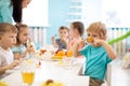 Group of kids have lunch in daycare