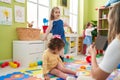 Group of kids having lesson sitting on floor at kindergarten Royalty Free Stock Photo