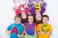 Group of kids holding alphabetical letters