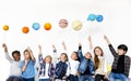 Group of Kids Holding Paper-craft Galaxy Symbol on White Background