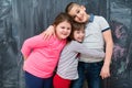 Group of kids hugging in front of chalkboard Royalty Free Stock Photo