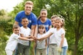 Group of kids joining hands with volunteers Royalty Free Stock Photo