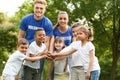 Group of kids joining hands with volunteers Royalty Free Stock Photo