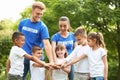 Group of kids joining hands with volunteers Royalty Free Stock Photo