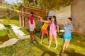 Group of kids play fun wet game with water guns Royalty Free Stock Photo