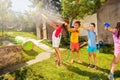 Group of kids play fun wet game with water pistols Royalty Free Stock Photo