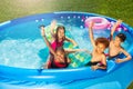 Group of kids play in swimming pool lifting hands Royalty Free Stock Photo