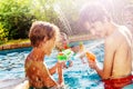 Group of kids play with water gun fight in pool Royalty Free Stock Photo