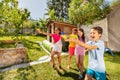 Kids play water gun fight in a team with friends Royalty Free Stock Photo