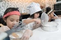 Group of kids are preparing the bakery in the kitchen .Children learning to cooking cookies.