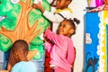 Group of kids put letters on the tree in nursery Royalty Free Stock Photo