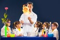 Group kids and scientist doing experiments with fire in laboratory Royalty Free Stock Photo