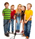 Group of kids singing to microphone