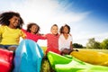 Group of kids sit with race sacks on the lawn Royalty Free Stock Photo