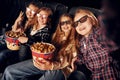 Group of kids sitting in cinema and watching movie together Royalty Free Stock Photo