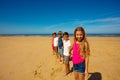 Group of kids stand together in a row on the beach Royalty Free Stock Photo