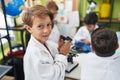 Group of kids students smiling confident using microscope at laboratory classroom Royalty Free Stock Photo