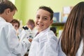 Group of kids students smiling confident using microscope at laboratory classroom Royalty Free Stock Photo