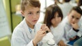 Group of kids students using microscope at laboratory classroom Royalty Free Stock Photo