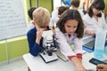 Group of kids students using microscope at laboratory classroom Royalty Free Stock Photo