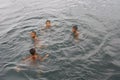 A group of kids swimming in a lake