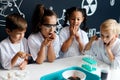 Group of kids and teachers carrying out a science experiment Royalty Free Stock Photo