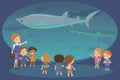 Group of kids watching sharks at oceanaruim aquarium excursion with a teacher. School or kindergarten students on filed