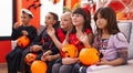 Group of kids wearing halloween costume saying hello with hand at home