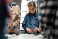 Group of kids working together on project with electric toys and robots at robotics classroom, close up on girl Royalty Free Stock Photo