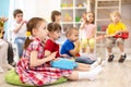 Group of kids 3-4 years old playing toy musical instruments. Early music education in kindergarten