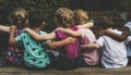 Group of kindergarten kids friends arm around sitting together Royalty Free Stock Photo