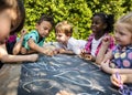 Group of kindergarten kids friends drawing art class outdoors