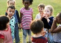 Group of kindergarten kids friends holding hands playing at park Royalty Free Stock Photo