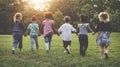 Group of kindergarten kids friends holding hands playing at park Royalty Free Stock Photo