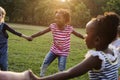 Group of kindergarten kids friends holding hands playing at park Royalty Free Stock Photo