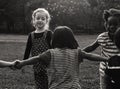 Group of kindergarten kids friends holding hands playing at park Royalty Free Stock Photo