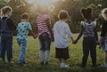 Group of kindergarten kids friends holding hands playing at park Royalty Free Stock Photo