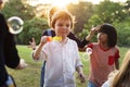 Group of kindergarten kids friends playing blowing bubbles fun Royalty Free Stock Photo