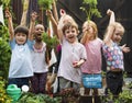 Group of kindergarten kids learning gardening outdoors Royalty Free Stock Photo