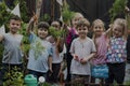 Group of kindergarten kids learning gardening outdoors Royalty Free Stock Photo