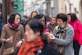 PRAGUE, CZECH REPUBLIC - 12TH APRIL 2019: Asian tourists sample the amazingly tasty schaumrollen food of Prague