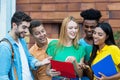 Group of latin and african american students talking about homework Royalty Free Stock Photo