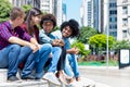 Group of latin american and afican hipster young adults in discussion in the city