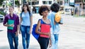 Group of latin american and african students on bus station Royalty Free Stock Photo