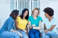 Group of latin and hispanic and african american female young adults watching movie clip at phone Royalty Free Stock Photo